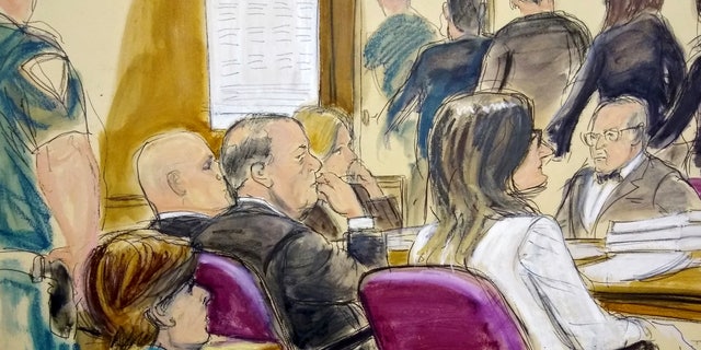 In this courtroom drawing, Harvey Weinstein, center, sits at the defense table surrounded by his attorneys as jurors file out of the courtroom after being told by the judge to go back and keep deliberating in Weinstein's rape case, Friday, Feb. 21, 2020, at Manhattan Supreme Court in New York. 