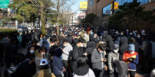 People line up to buy face masks at a store in Daegu, South Korea, Monday, Feb. 24, 2020. South Korea's President Moon Jae-in on Sunday put the country on its highest alert for infectious diseases and says officials should take "unprecedented, powerful" steps to fight a viral outbreak. (Lee Moo-ryul/Newsis via AP)