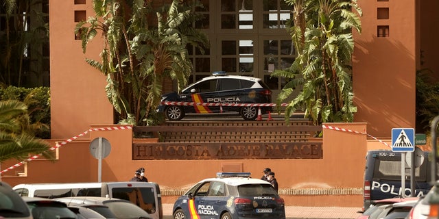 Spanish police officers stand outside the H10 Costa Adeje Palace hotel in Tenerife, on Tuesday, Feb. 25, 2020. Spanish officials say a tourist hotel on the Canary Island hotel of Tenerife has been placed in quarantine after an Italian doctor staying there tested positive for a new virus from China that has infected thousands worldwide.