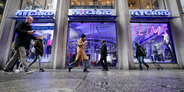 Pedestrians pass the storefront of Peter Nygard's Times Square headquarters on Feb. 25. (AP Photo/John Minchillo)
