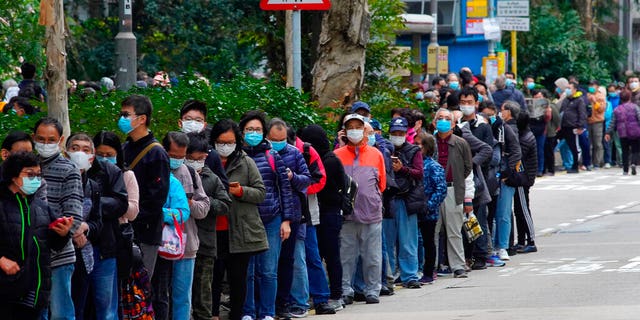 In this Feb. 5, 2020, file photo, citizens line up to buy face masks in Hong Kong. Fear of the spreading coronavirus has led to a global run on sales of face masks despite medical experts' advice that most people who aren't sick don't need to wear them. 