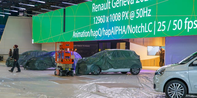 Cars are pictured as workers stop the preparation of the 90th Geneva International Motor Show, GIMS, at Palexpo, in Geneva, Switzerland, Friday, Feb. 28, 2020. (Salvatore di Nolfi/Keystone via AP)