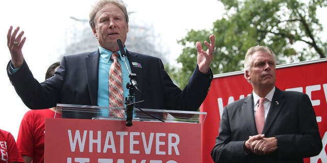 Andy Parker (L), the father of murdered TV reporter Alison Parker, speaks while flanked by Virginia Governor Terry McAuliffe (D) (R), during an anti-gun rally on Capitol Hill Sept. 10, 2015, in Washington, D.C.