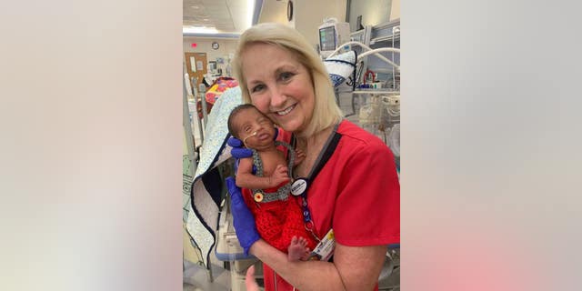Nurse Lissa McGowan holding Alexander Caldwell. The NCIU nurse took care of the baby's father when he was prematurely born years ago in the same hospital.