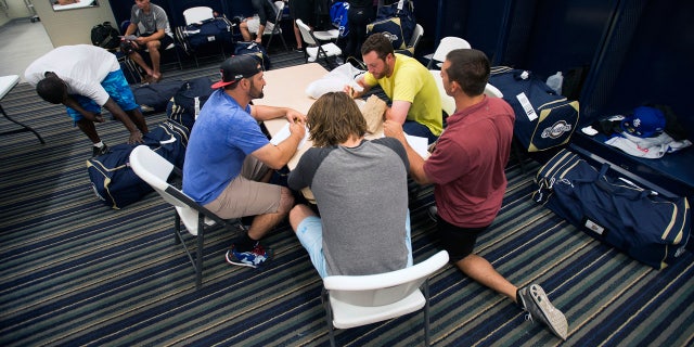 FILE - In this April 8, 2015, file photo, members of the Biloxi Shuckers minor league baseball team eat lunch before practice. (AP Photo/Michael Spooneybarger, File)