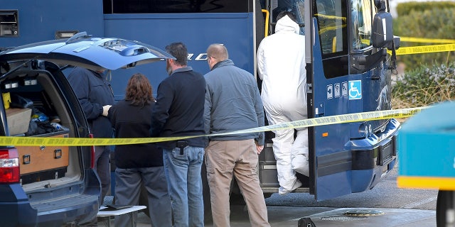 Investigators are seen outside of a Greyhound bus after a passenger was killed on board on Monday, in Lebec, Calif. (AP Photo/Jayne Kamin-Oncea)