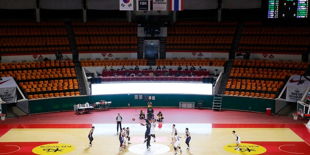 In an empty seat stadium, the 2021 FIBA Asia Cup qualifiers group A basketball game between South Korea and Thailand Sunday, Feb. 23, 2020, in Seoul, South Korea. The basketball game held without spectators as a precaution against the COVID-19. (Hong Hae-in/Yonhap via AP)