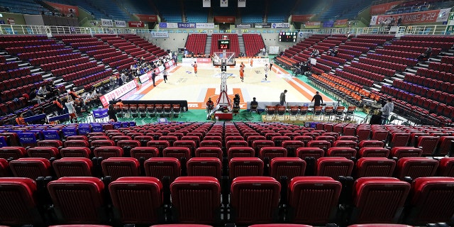 Stadium seats are empty during the Korean Basketball League between Incheon Electroland Elephants and Anyang KGC clubs in Incheon, South Korea, Wednesday, Feb. 26, 2020. The basketball game held without spectators as a precaution against the COVID-19. (Yun Tai-hyun/Yonhap via AP)