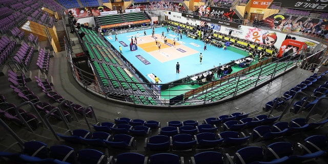 Stadium seats are empty during the pro volleyball V-league between OK Savingbank Rush&Cash and KB Insurance Stars in Ansan, South Korea, Wednesday, Feb. 26, 2020. The volleyball game held without spectators as a precaution against the COVID-19. (Hong Ki-won/Yonhap via AP)