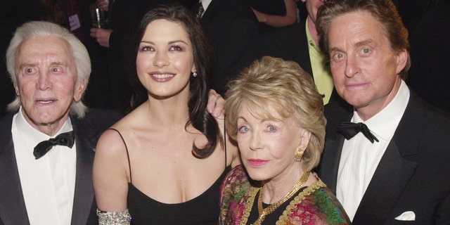 From left to right: Kirk Douglas, Catherine Zeta-Jones, Anne Buydens and Michael Douglas. (Photo by Chris Weeks/Liaison via Getty)