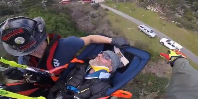 Ian Irwin can be seen being airlifted out of a wooded area in Northern California on Saturday.