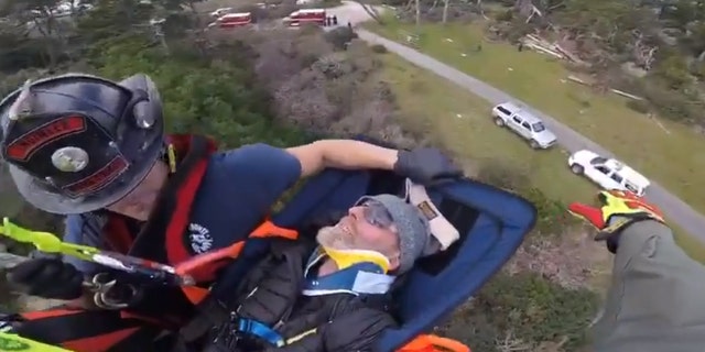 Ian Irwin can be seen being airlifted out of a wooded area in Northern California on Saturday.