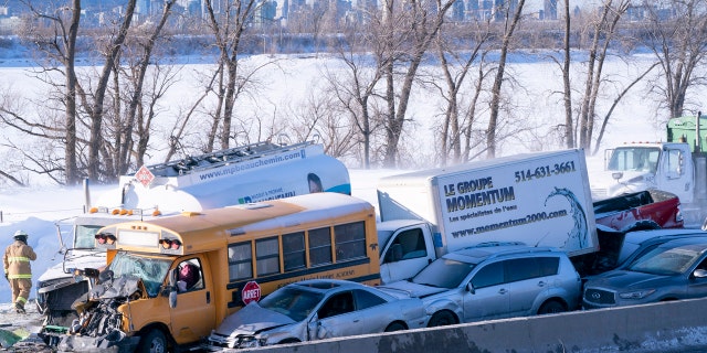 Emergency personnel gather at the scene following a multi-vehicle crash on the south shore of Montreal in La Prairie, Quebec, Wednesday, Feb. 19, 2020.