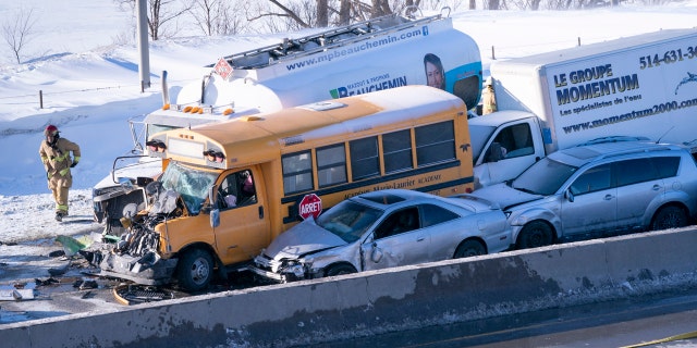 Emergency personnel gather at the scene following a multi-vehicle crash on the south shore of Montreal in La Prairie, Quebec, Wednesday, Feb. 19, 2020.
