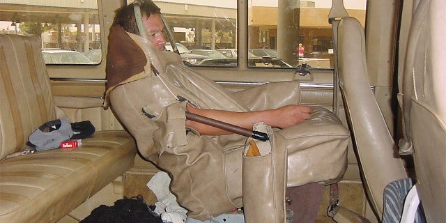 Enrique Aquilar Canchola, a 42-year-old Mexican national, hides in the seat of a vehicle as part of an attempt to illegally emigrate to the United States at the San Ysidro border crossing in San Ysidro, California, June 7, 2001. . HK/SV - RP2DRIDIHJAA