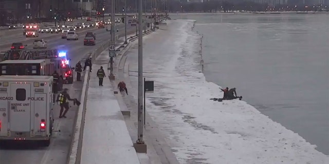Two Chicago SWAT officers can be seen responding after a man fell into Lake Michigan early Saturday.