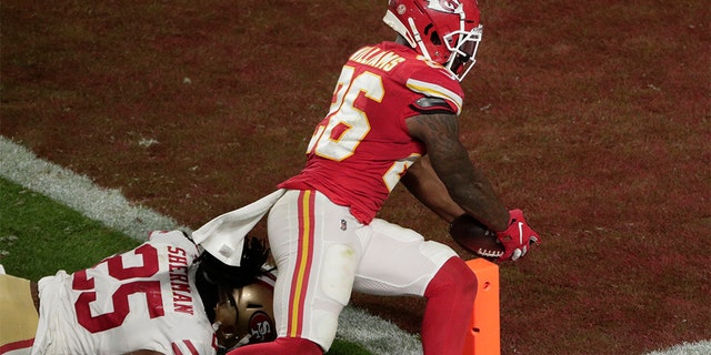 Kansas City Chiefs' Damien Williams (26) scores a touchdown as San Francisco 49ers' Richard Sherman (25) attempts to defend, during the second half of the NFL Super Bowl 54 football game Sunday, Feb. 2, 2020, in Miami Gardens, Fla. (AP Photo/Charlie Riedel)