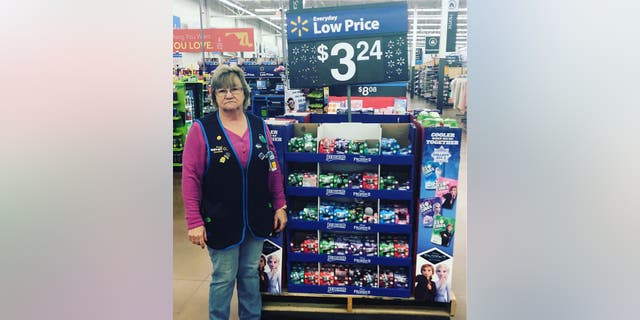 Charlene models her signature look in front of Walmart merchandise.