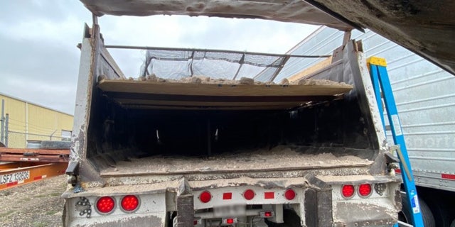 CBP officials found 36 migrants hidden beneath a compartment that created the impression that the truck was filled with gravel and dirt.