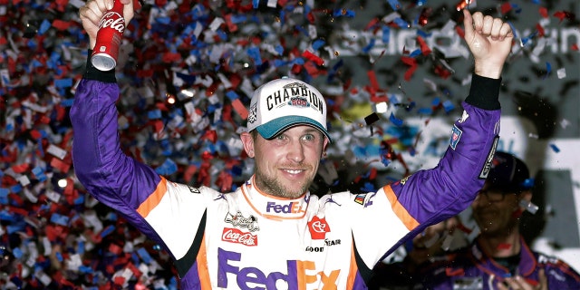 Denny Hamlin celebratinf in Victory Lane after winning the Daytona 500. (AP Photo/John Raoux)