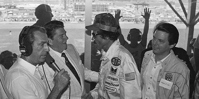 President Ronald Reagan congratulates stock car driver Richard Petty, who won the Firecracker 400 race at the Daytona International Speedway in Daytona Beach, Fla., in 1984. (AP Photo/Ira Schwarz, File)