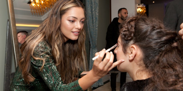 Demi-Leigh Nel-Peters puts makeup on one of the guests at the "Night to Shine" in Albania.