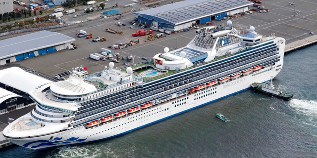 The cruise ship Diamond Princess is anchored at Yokohama Port for supplies replenished in Yokohama, south of Tokyo, Thursday, Feb. 6, 2020. The 3,700 people on board faced a two-week quarantine in their cabins. Health workers said 10 more people from the Diamond Princess were confirmed sickened with the virus, in addition to 10 others who tested positive on Wednesday. The 10 will be dropped off as the ship docks and transferred to nearby hospitals for further test and treatment. (Kenzaburo Fukuhara/Kyodo News via AP)