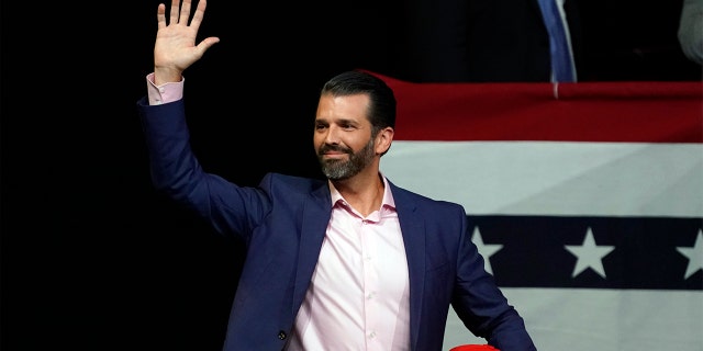 Donald Trump Jr. waves at campaign rally before President Donald Trump appears Wednesday, Feb. 19, 2020 in Phoenix. (AP Photo/Rick Scuteri)