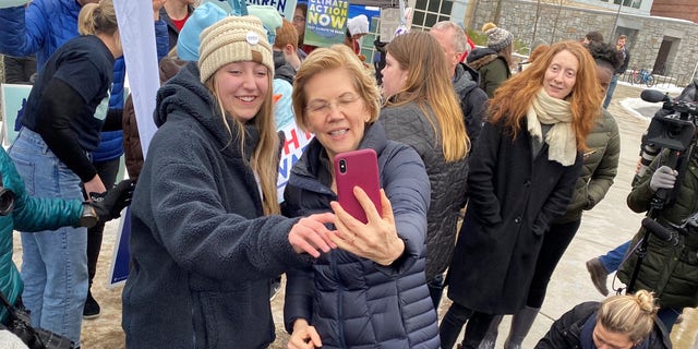 Democratic presidential candidate Sen. Elizabeth Warren of Massachusetts takes seflies with supporters at the University of New Hampshire on primary day - in Durham, NH on Feb. 11, 2020
