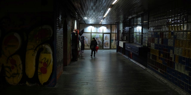 A woman walks through an underground passage during a rainy day in Belgrade, Serbia, Wednesday, Feb. 5, 2020. Weather forecasts predict changeable weather during the next few days.