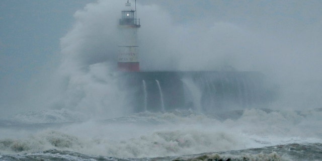 Waves crash over the harbour and a lighthouse, as Storm Ciara hits Newhaven, on the south coast of England, Sunday, Feb. 9, 2020.