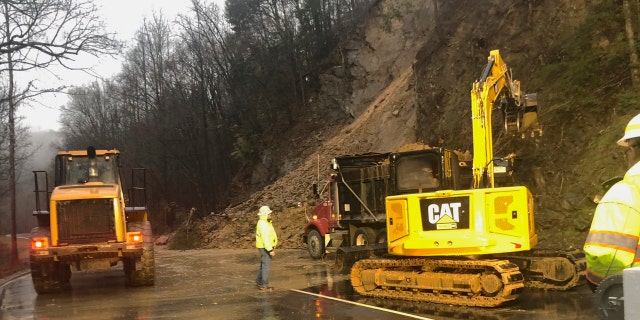 In this photo provided by the National Park Service, Great Smoky Mountains National Park and Federal Highways Administration staff clear mud and rock from the Spur connecting the Tennessee tourist towns of Gatlinburg and Pigeon Forge, near the Great Smoky Mountains National Park, Tuesday, Feb. 11, 2020.