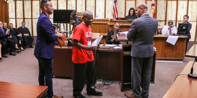 Leonel Frage, 60, who hasn't been able to vote in over 15 years, walks away holding a paper restoring his right to vote during a special court hearing aimed at restoring the right to vote under Florida's Amendment 4 in a Miami-Dade County courtroom on November 8, 2019, in Miami, Florida.