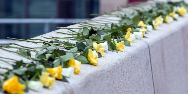 Flowers in the colours of Dresden are lying on the Altmarkt at a memorial to the victims of the bombing of Dresden in the Second World War 75 years ago, Dresden, Germany. (Jens Buettner/dpa via AP)
