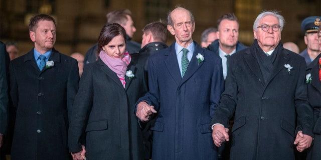 German Federal President Frank-Walter Steinmeier, centre, stands with various dignitaries and guest including Britain's Duke of Kent, 2nd right, and Michael Kretschmer Prime Minister of Saxony, left, and his partner Annett Hofmann, as they join a human chain, marking the 75th anniversary of the destruction of Dresden. (Jens B'ttner/dpa via AP)