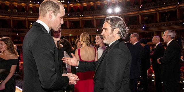 Prince William, Duke of Cambridge speaks with BAFTA winner Joaquin Phoenix at the EE British Academy Film Awards 2020 at Royal Albert Hall on February 2, 2020, in London, England.