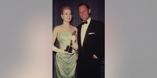 Grace Kelly and William Holden attend the 27th Academy Awards ceremony.
