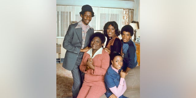 Portrait of the cast of the television show 'Good Times,' Los Angeles, California, August 5, 1977. Pictured are, front row, American actresses Esther Rolle (1920 - 1998) (left) and BernNadette Stanis; back row, from left, American actors Jimmie Walker, Ja'net DuBois, and Ralph Carter.