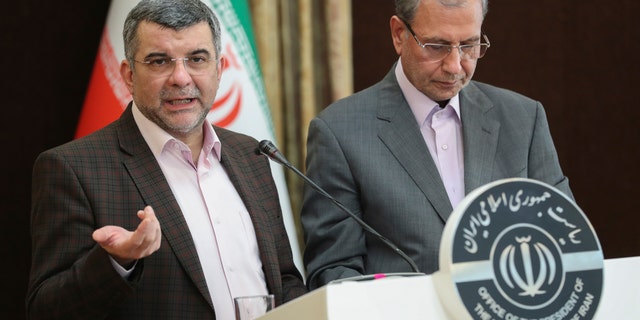 Iraj Harirchi, left, speaks at a press briefing on Monday with government spokesman Ali Rabiei, in Tehran, a day before he released a video saying that he tested positive for the virus.