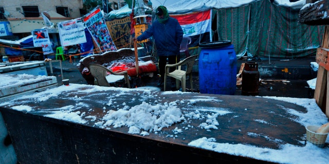 Fresh snow falls in Tahrir Square while anti-government protesters stage a sit-in in Baghdad, Iraq, Tuesday, Feb. 11, 2020.