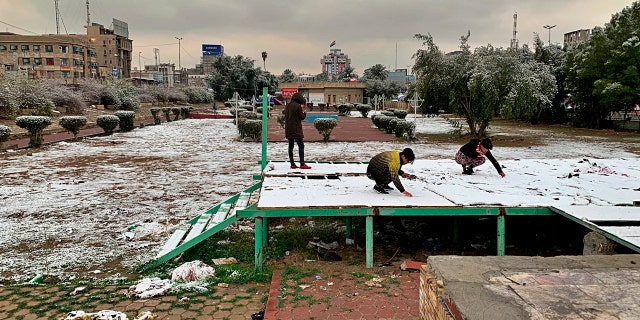 People play in the fresh snow in Baghdad, Iraq, Tuesday, Feb. 11, 2020.