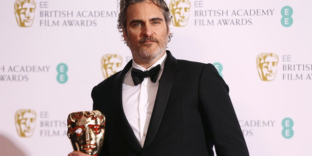Joaquin Phoenix poses with his award for Best Actor for the film Joker, backstage at the Bafta Film Awards, in central London, Sunday, Feb. 2, 2020. (Photo by Joel C Ryan/Invision/AP)