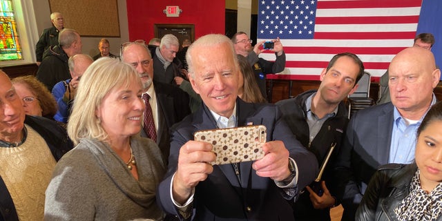 Former Vice President Joe Biden takes selfies with supporters during a campaign event in Somersworth, N.H. on Feb. 5, 2020