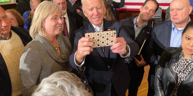 Former Vice President Joe Biden takes selfies with supporters during a campaign event in Somersworth, N.H. on Feb. 5, 2020