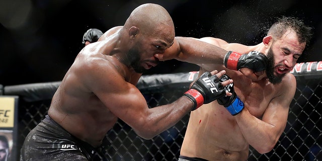 Jon Jones, left, connecting with a punch to the face of Dominick Reyes at UFC 247 in Houston. (AP Photo/Michael Wyke)