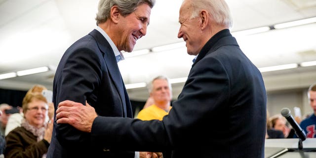 Democratic presidential candidate former Vice President Joe Biden smiles as former Secretary of State John Kerry, left, takes the podium to speak at a campaign stop at the South Slope Community Center in North Liberty, Iowa. (AP Photo/Andrew Harnik)