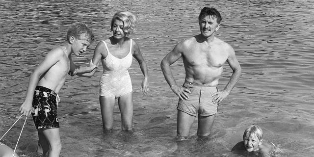 Kirk Douglas his wife Anne and their two children Eric and Peter in Monaco in 1967. (Photo credit should read AFP/AFP via Getty Images)