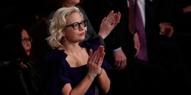U.S. Sen. Kyrsten Sinema, D-Ariz., applauds during former President Trump's State of the Union address at the U.S. Capitol in Washington, Feb. 4, 2020. (Getty Images)