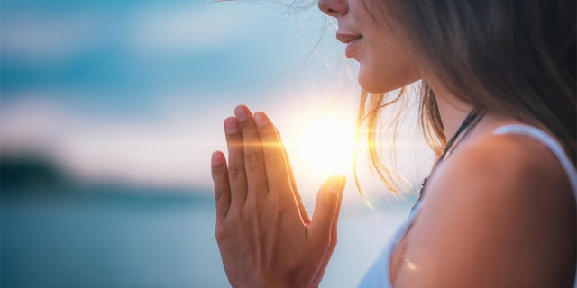 woman with praying hands
