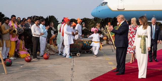 President Donald Trump, with first lady Melania Trump, are greeted as they step off Air Force One, upon arrival at Agra Air Base, Monday, Feb. 24, 2020, in Agra, India. (AP Photo/Alex Brandon)